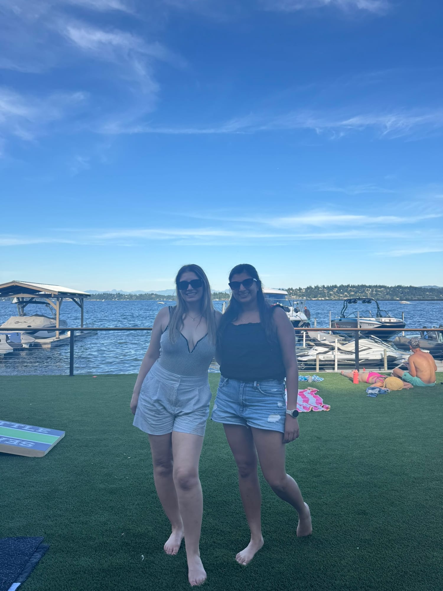 Sarah and me at the waterfront with cornhole boards and boats