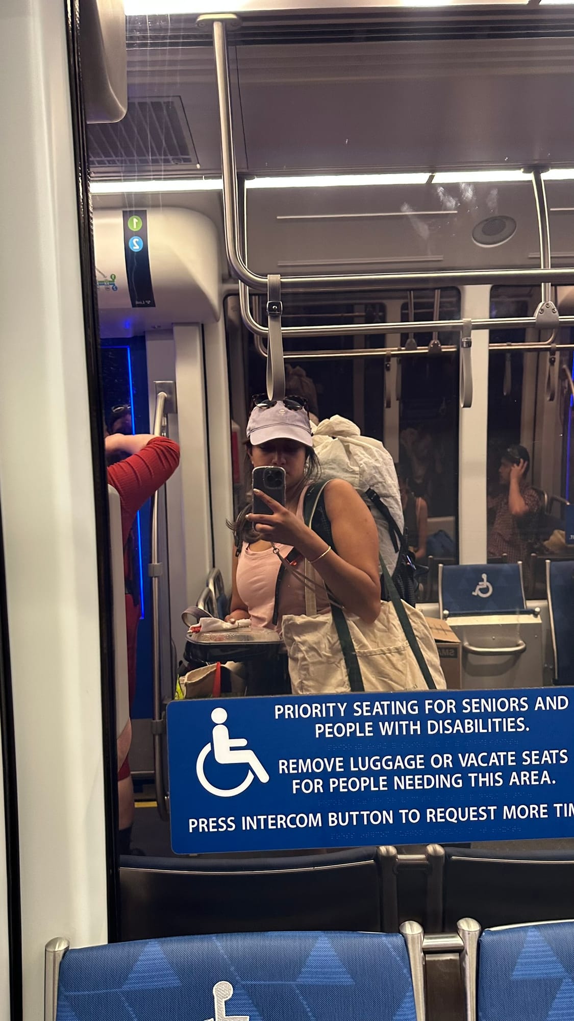 Light rail mirror selfie heading home after Duck Dodge, backpack and all