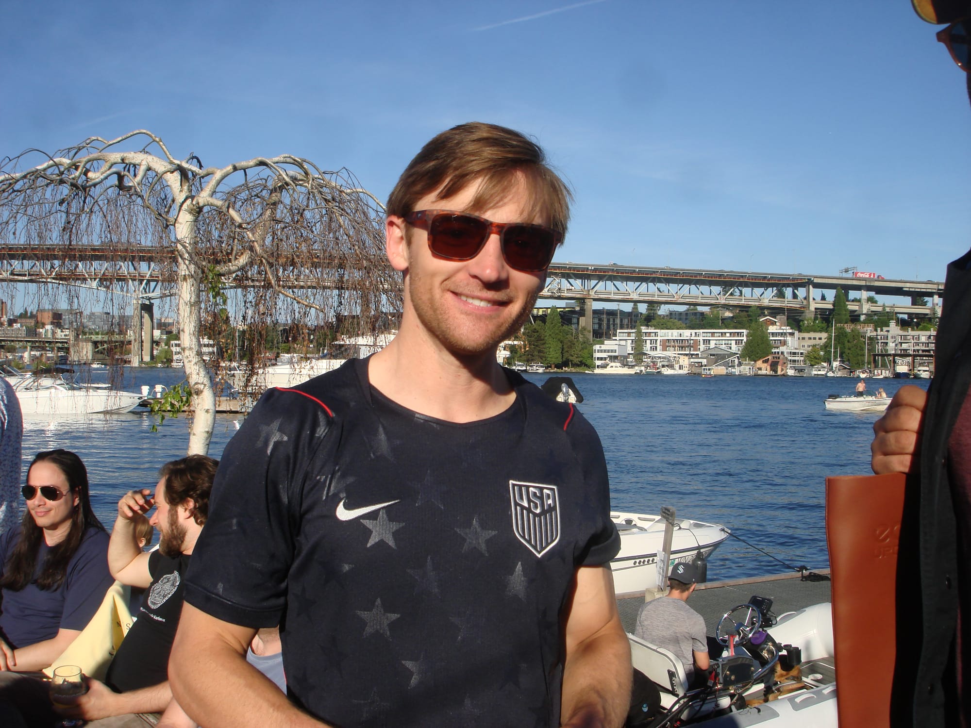 Friend at the birthday party on the water, Lake Union bridge behind