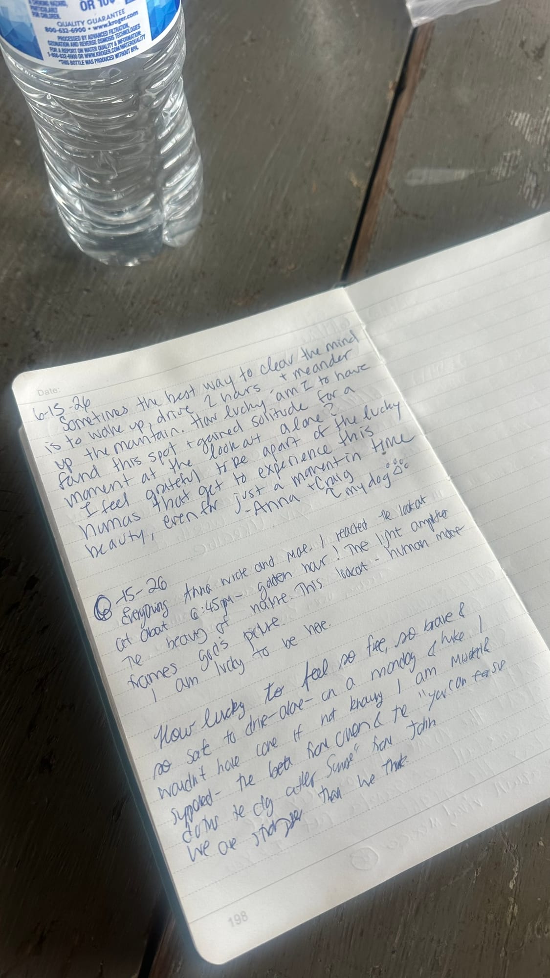 Journal open on the lookout table, Baker visible through the window