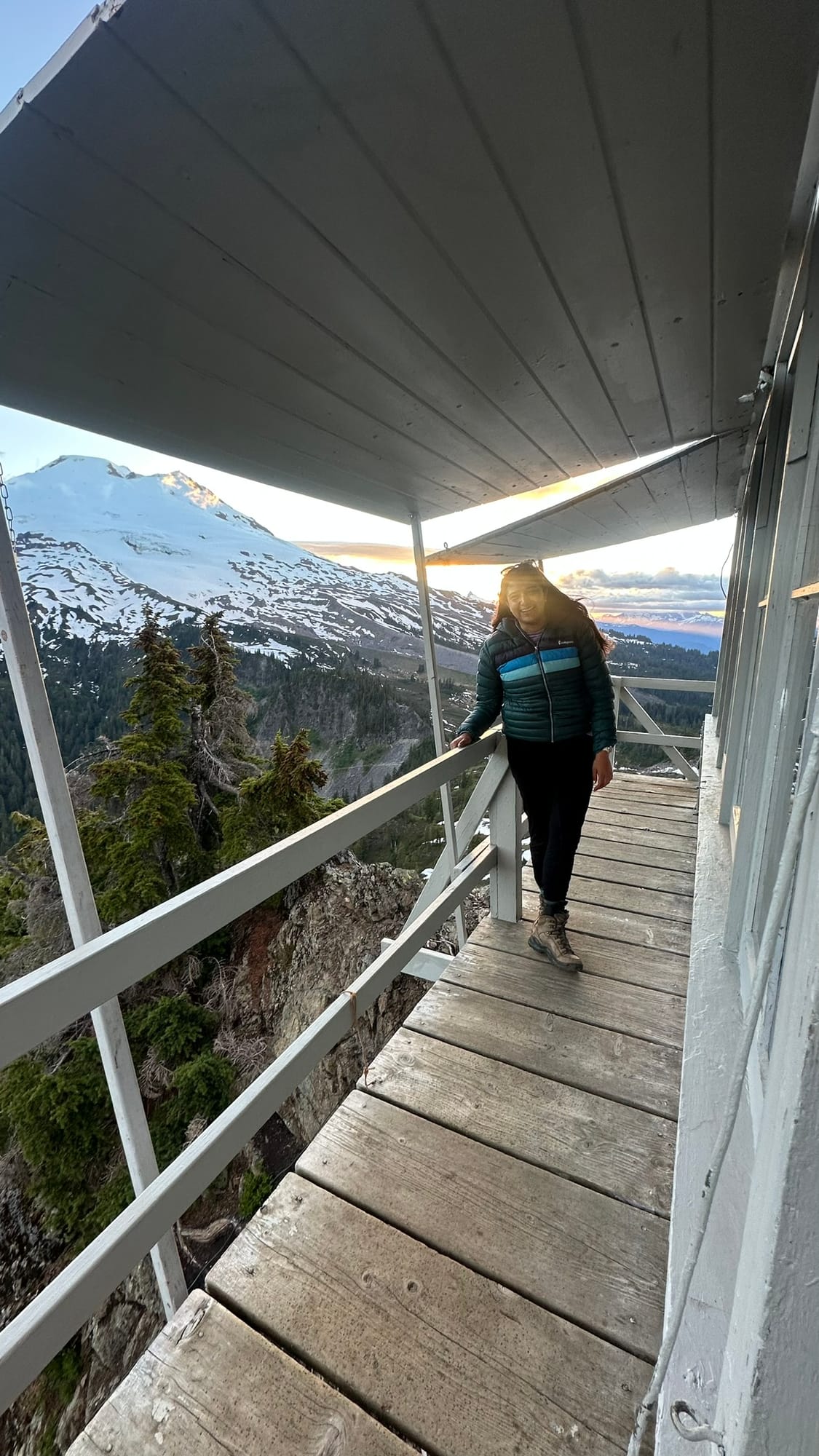 Walking along the porch at sunrise with Mt. Baker lit up orange behind