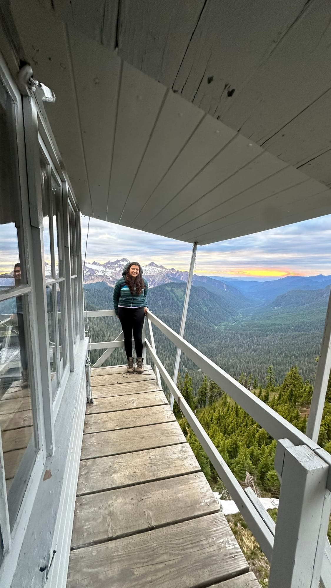 Standing on the lookout porch at sunset with the Cascades behind