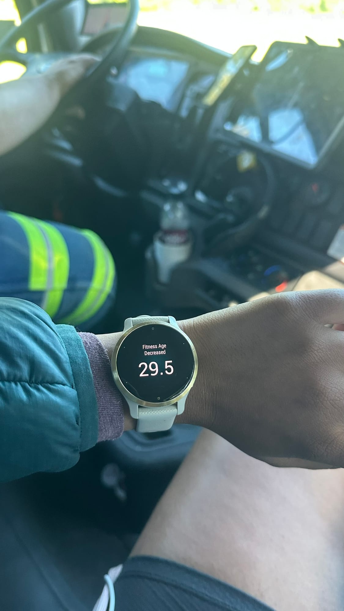 Garmin watch in the tow truck cab showing 'Fitness Age Decreased: 29.5'